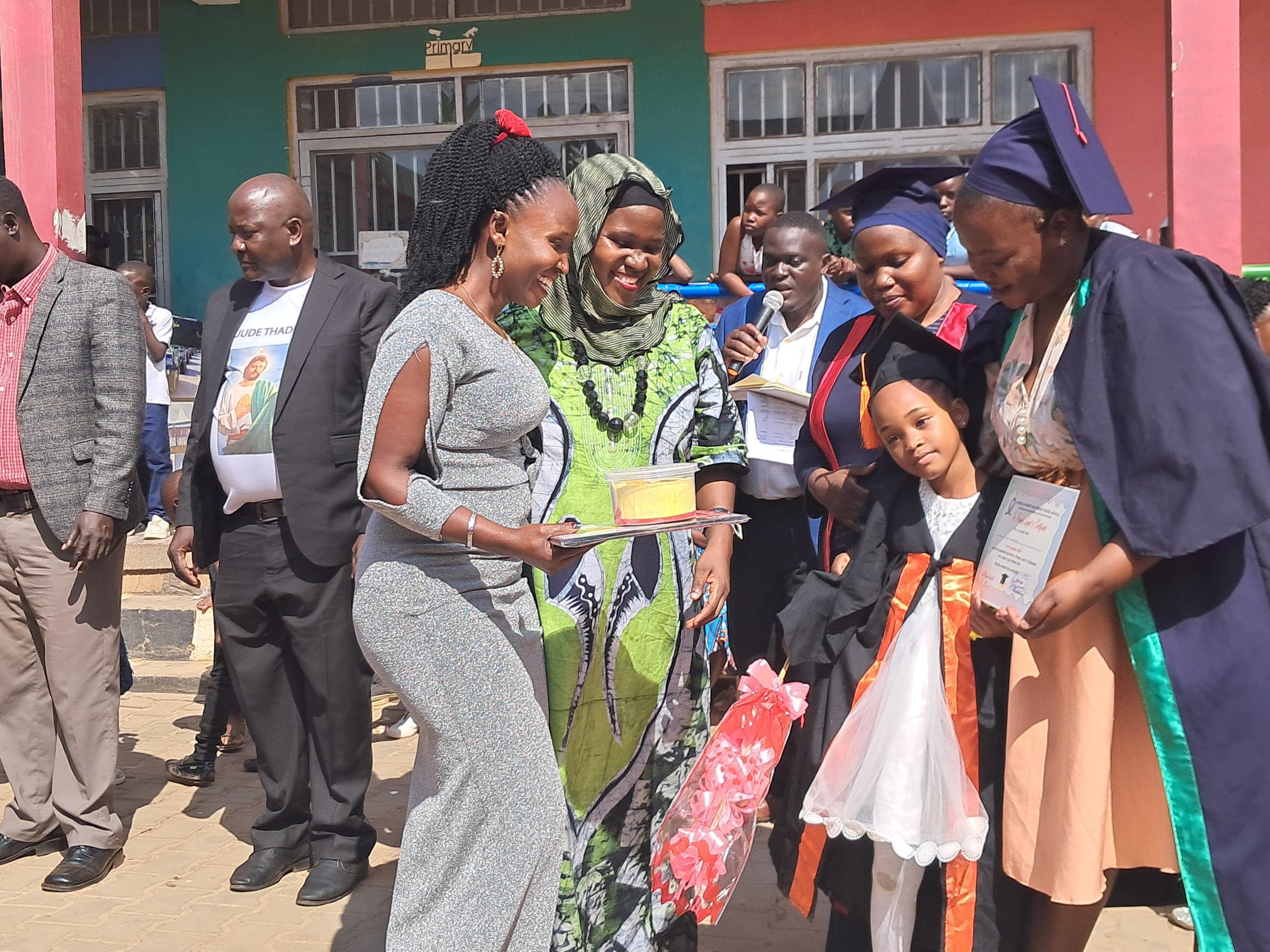 The directress, Ms Nanono Safina (With a vail) rewarding Top class achievers